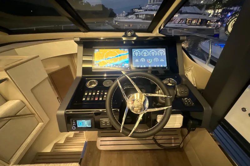 Slide: The Image of 2026 Cruisers Yachts 50 Fly helm with advanced navigation displays and controls. - 15