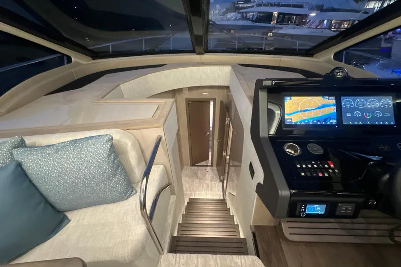 Slide: The Image of 2026 Cruisers Yachts 50 Fly interior with modern helm and navigation displays. - 16
