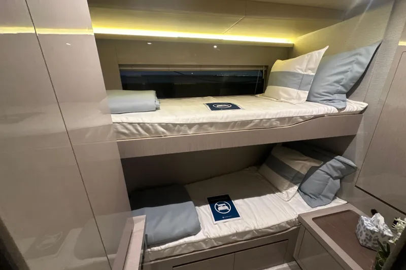 Slide: The Image of Luxurious 2026 Cruisers Yachts 50 Fly cabin with modern bunk beds and elegant lighting. - 17