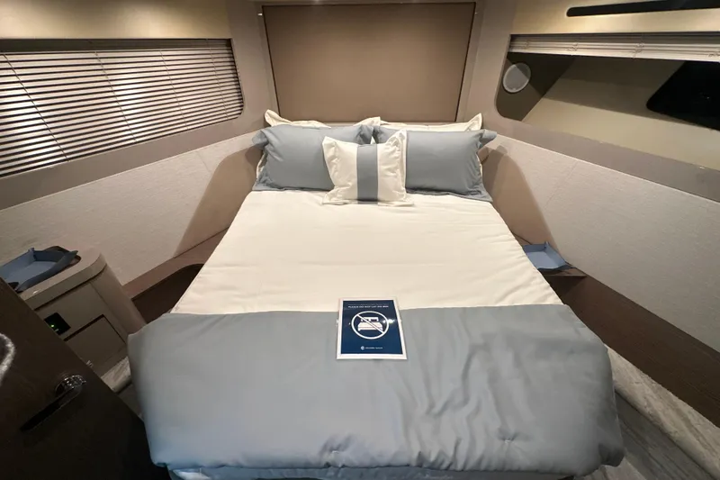 Slide: The Image of Luxurious bedroom interior of 2026 Cruisers Yachts 50 Fly with elegant bedding. - 18