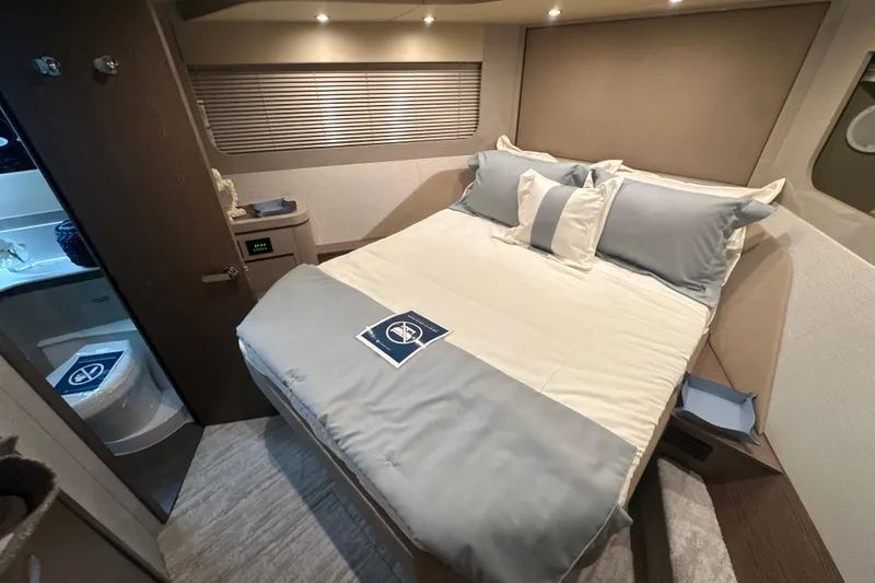 Slide: The Image of Luxurious bedroom interior of 2026 Cruisers Yachts 50 Fly, featuring elegant bedding and modern design. - 19