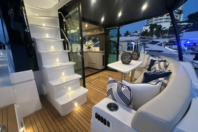Slide: The Image of Luxurious 2026 Cruisers Yachts 50 Fly interior with elegant seating and ambient lighting. - 2