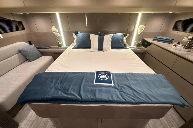 Slide: The Image of Luxurious 2026 Cruisers Yachts 50 Fly cabin with elegant bedding and modern decor. - 25
