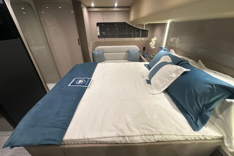 Slide: The Image of Luxurious bedroom interior of 2026 Cruisers Yachts 50 Fly, featuring elegant bedding and modern design. - 26