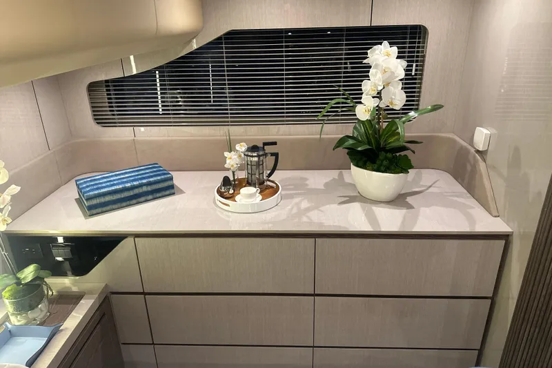 Slide: The Image of Luxurious interior of 2026 Cruisers Yachts 50 Fly with elegant decor and orchid plant. - 30