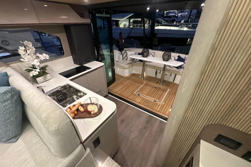 Slide: The Image of Luxurious interior of 2026 Cruisers Yachts 50 Fly with modern kitchen and elegant dining area. - 38