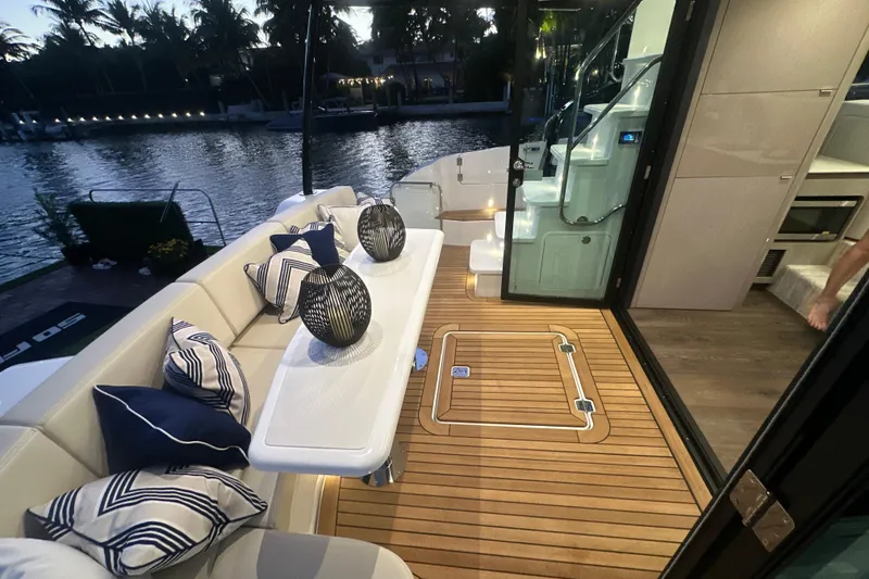 Slide: The Image of Luxurious 2026 Cruisers Yachts 50 Fly deck with elegant seating and scenic waterfront view. - 4