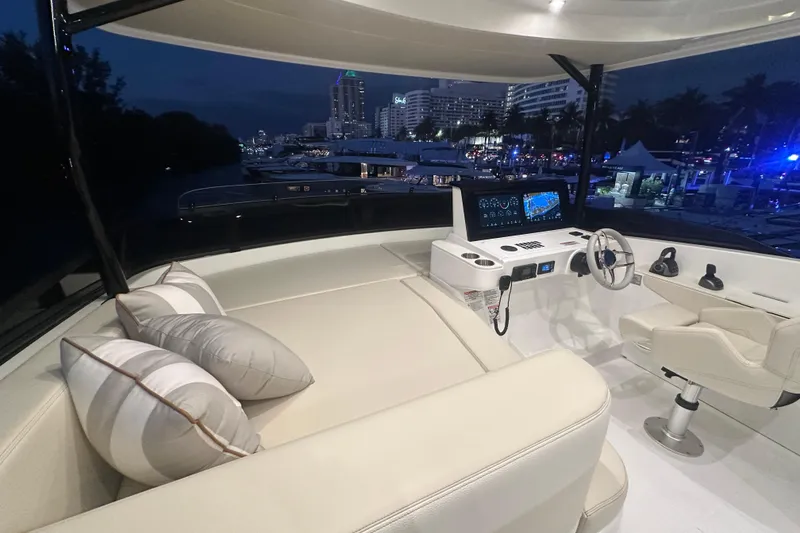 Slide: The Image of Luxurious 2026 Cruisers Yachts 50 Fly bridge with modern helm and plush seating at night. - 41