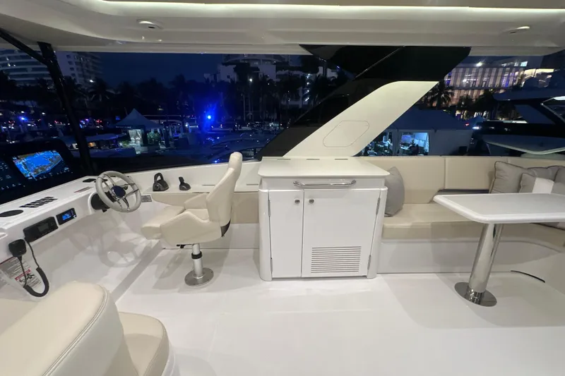 Slide: The Image of Luxurious 2026 Cruisers Yachts 50 Fly interior with helm, seating, and table at night. - 42