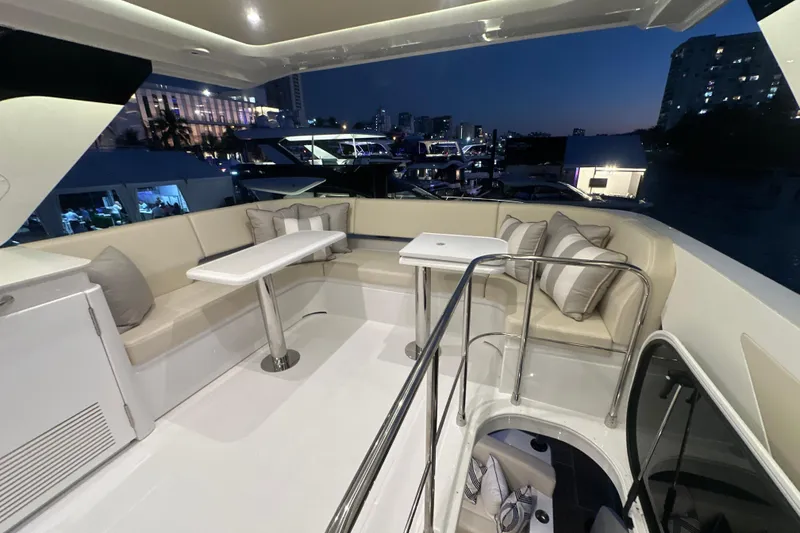 Slide: The Image of Luxurious 2026 Cruisers Yachts 50 Fly interior with elegant seating and tables at dusk. - 43