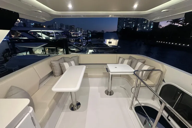 Slide: The Image of Luxurious 2026 Cruisers Yachts 50 Fly deck with elegant seating and tables at dusk. - 44