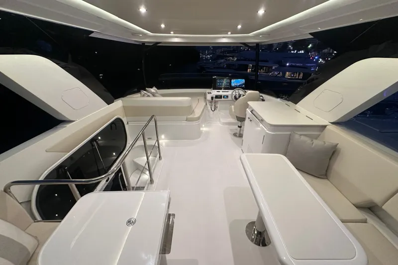 Slide: The Image of Luxurious interior of 2026 Cruisers Yachts 50 Fly, featuring modern seating and navigation area. - 45