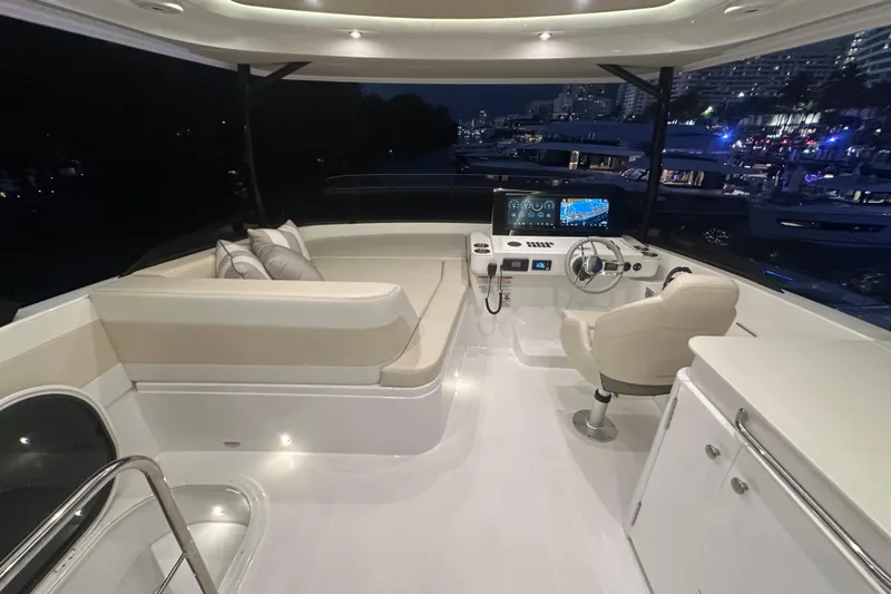 Slide: The Image of Luxurious 2026 Cruisers Yachts 50 Fly bridge with modern helm and seating at night. - 46