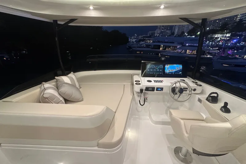 Slide: The Image of Luxurious 2026 Cruisers Yachts 50 Fly helm with plush seating and advanced navigation displays. - 48