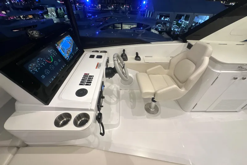 Slide: The Image of Helm station of 2026 Cruisers Yachts 50 Fly, featuring modern controls and navigation displays. - 50