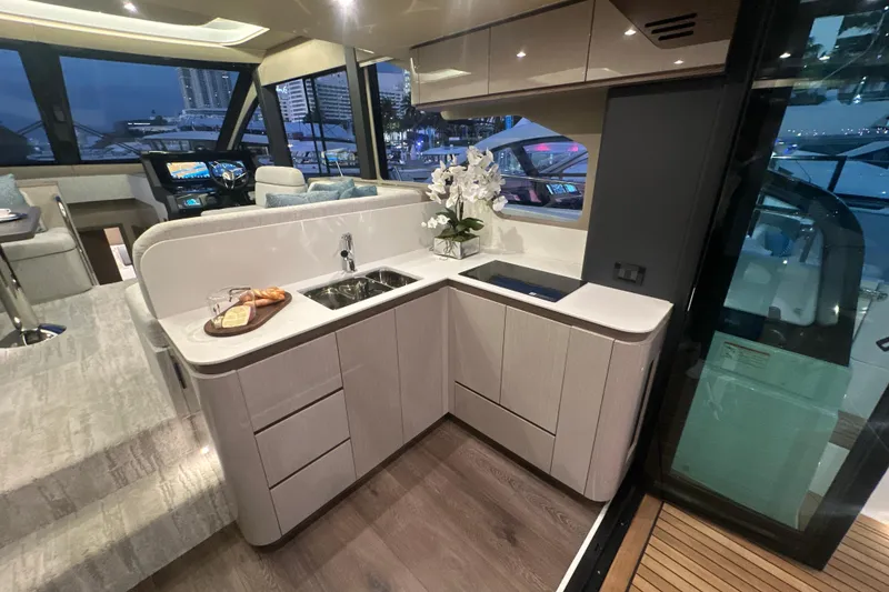 Slide: The Image of Luxurious interior of 2026 Cruisers Yachts 50 Fly with modern kitchen and elegant decor. - 6