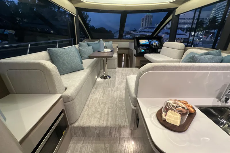 Slide: The Image of Luxurious interior of 2026 Cruisers Yachts 50 Fly with modern seating and helm. - 8