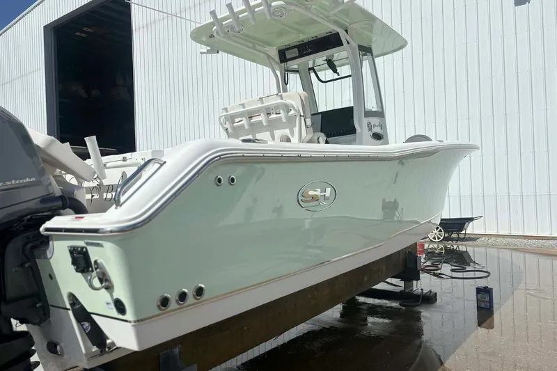 Slide: The Image of 2021 Sea Hunt boat in a marina, showcasing sleek design and modern features. - 3