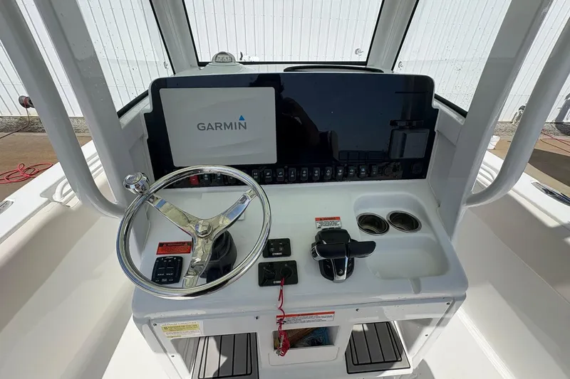 Slide: The Image of 2021 Sea Hunt boat dashboard with Garmin display and steering wheel. - 9