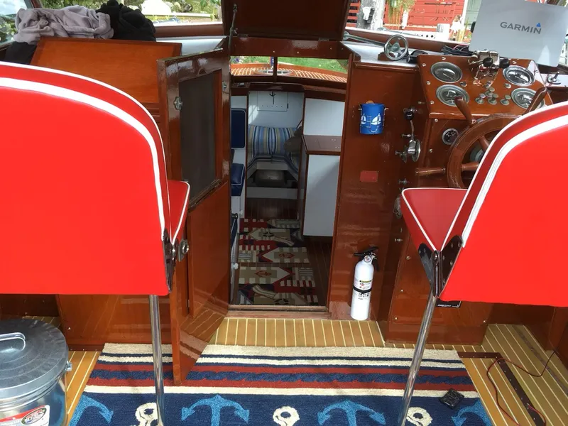 Slide: The Image of Interior of a 1956 Chris-Craft Captain boat with red seats and nautical decor. - 10