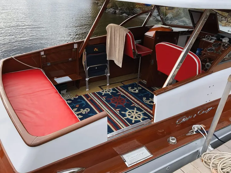 Slide: The Image of 1956 Chris-Craft Captain boat interior with red seating and nautical-themed decor. - 13