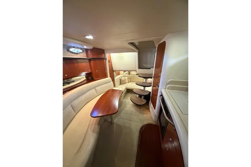Slide: The Image of Interior of 2005 Sea Ray Sundancer 320 yacht with elegant seating and wooden accents. - 11