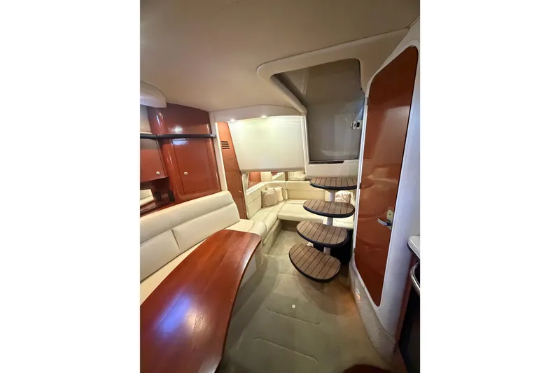 Slide: The Image of 2005 Sea Ray Sundancer 320 interior with elegant wood finishes and cozy seating area. - 12