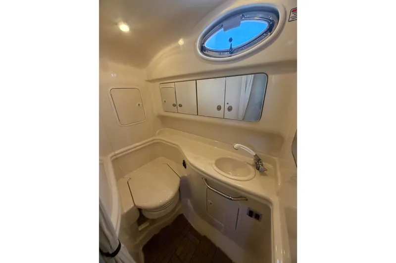 Slide: The Image of 2005 Sea Ray Sundancer 320 bathroom with sink, toilet, and storage cabinets. - 14