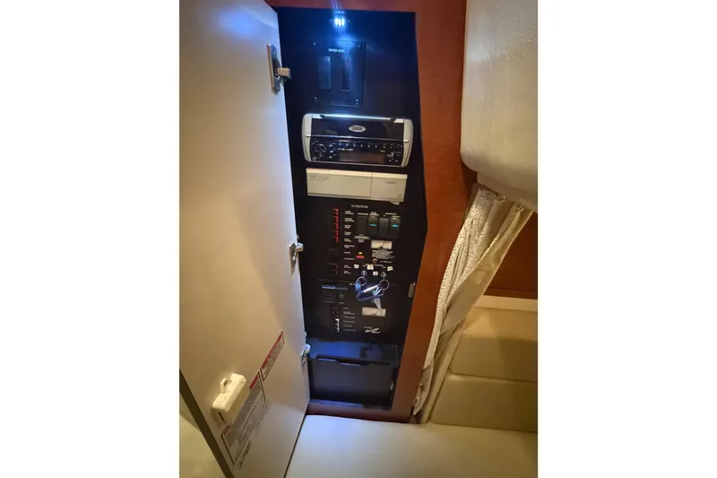 Slide: The Image of 2005 Sea Ray Sundancer 320 helm with steering wheel, gauges, and waterfront view. - 5