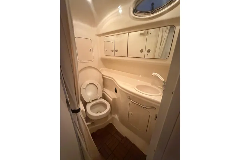 Slide: The Image of 2005 Sea Ray Sundancer 320 interior with seating and table, shaded by a black canopy. - 6