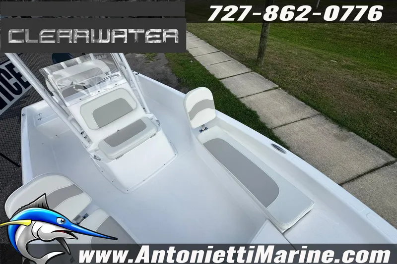 Slide: The Image of 2026 Clearwater 2100 Bay boat interior with seating, contact info, and website details. - 19