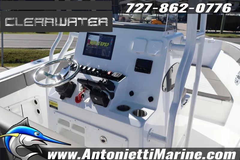 Slide: The Image of 2026 Clearwater 2300 boat dashboard with GPS, steering wheel, and controls. - 23