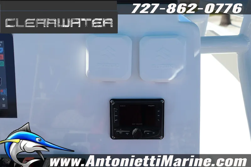 Slide: The Image of Clearwater 2300 boat dashboard with controls, logo, and contact information, 2026 model. - 24