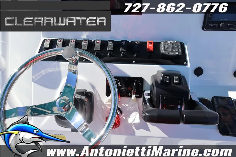 Slide: The Image of Clearwater 2300 boat dashboard with steering wheel and controls, 2026 model. - 25