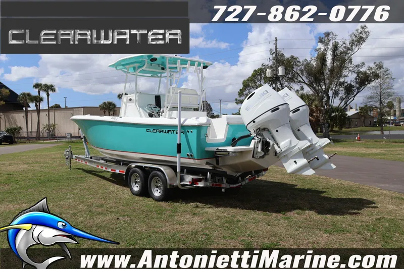 Slide: The Image of 2026 Clearwater 2800 CC boat on trailer, displayed outdoors with dual engines. - 3