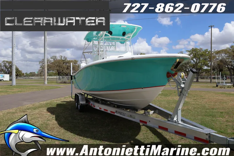 Slide: The Image of 2026 Clearwater 2800 CC boat on trailer, displayed outdoors with contact details and website. - 4