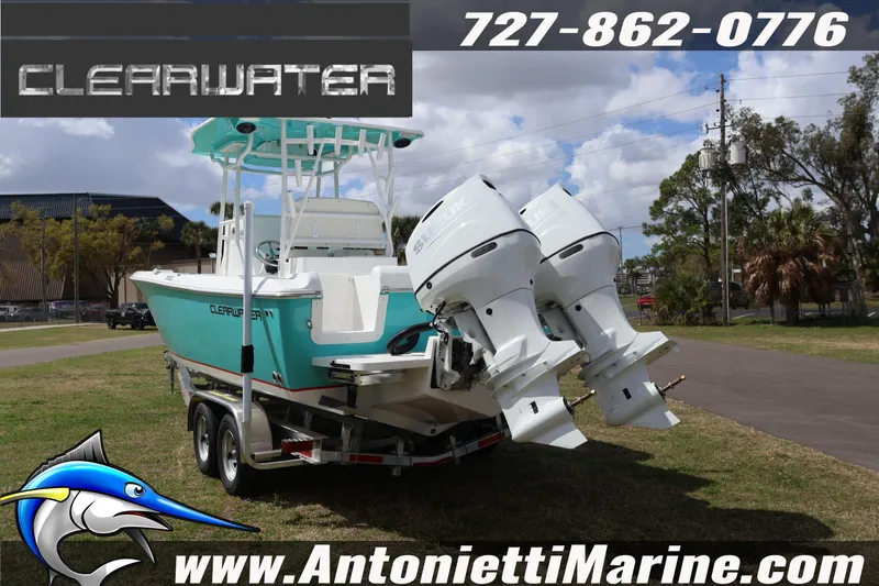 Slide: The Image of 2026 Clearwater 2800 CC boat with dual engines on a trailer, displayed outdoors. - 6