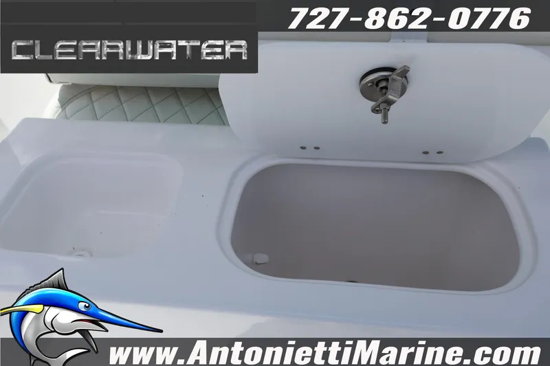 Slide: The Image of 2026 Clearwater 2800 CC boat interior with storage compartment and contact details. - 14