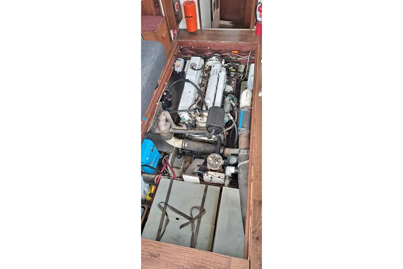 Slide: The Image of Engine compartment of a 1979 Mainship 34 Sedan boat, showcasing mechanical components. - 12