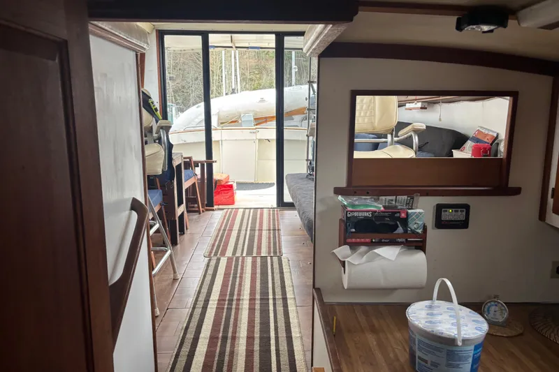 Slide: The Image of Interior of a 1979 Mainship 34 Sedan boat with striped rug and seating area. - 13