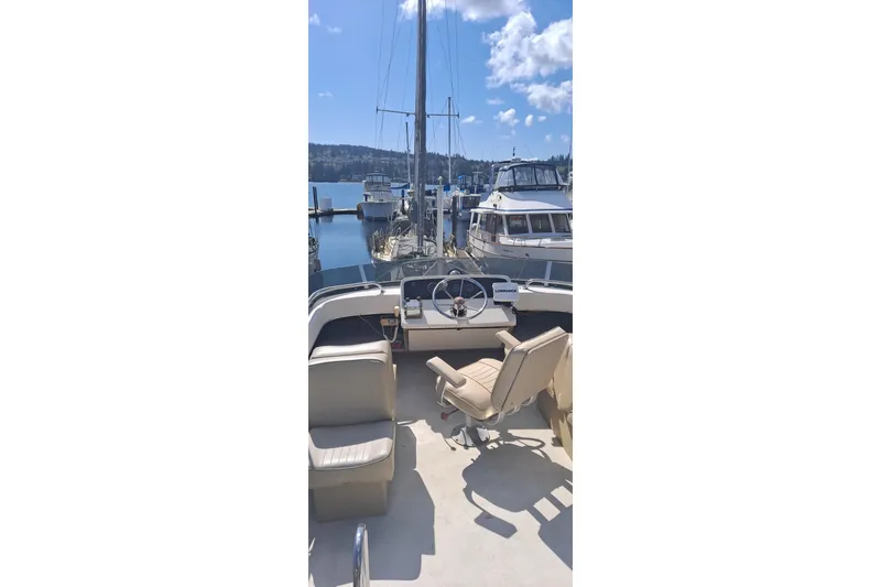 Slide: The Image of 1979 Mainship 34 Sedan boat docked at marina, sunny day, clear sky, calm water. - 3