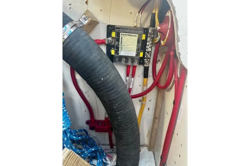 Slide: The Image of Electrical system inside 1986 Hunter Passage 450 sailboat, featuring SafetyHub 150 and wiring components. - 10