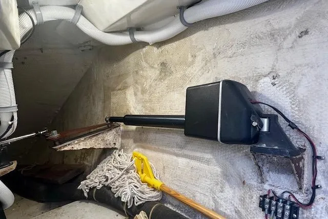 Slide: The Image of Interior view of 1986 Hunter Passage 450 sailboat showing mechanical components and storage area. - 11
