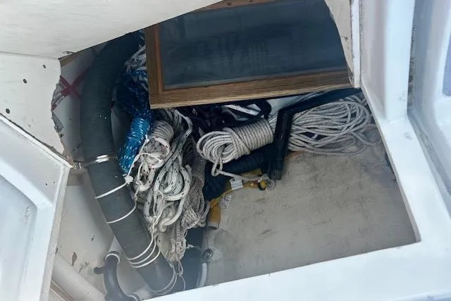 Slide: The Image of Storage compartment on 1986 Hunter Passage 450 sailboat with ropes and equipment. - 12