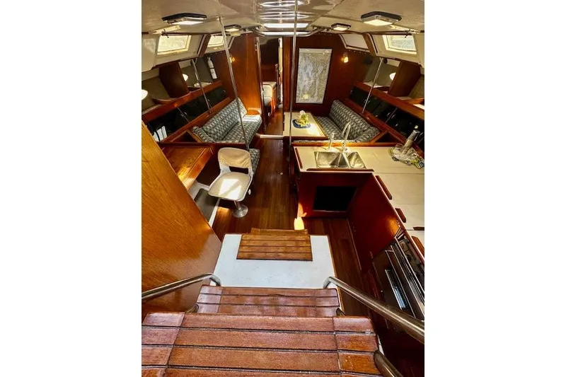 Slide: The Image of Interior of 1986 Hunter Passage 450 yacht with wooden finishes and cozy seating area. - 22