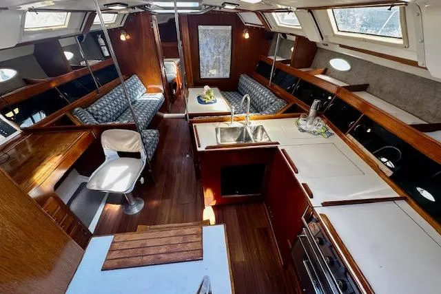 Slide: The Image of Interior of 1986 Hunter Passage 450 sailboat with kitchen and seating area. - 23