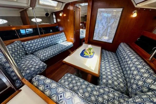 Slide: The Image of 1986 Hunter Passage 450 yacht interior with patterned seating and wooden finishes. - 24
