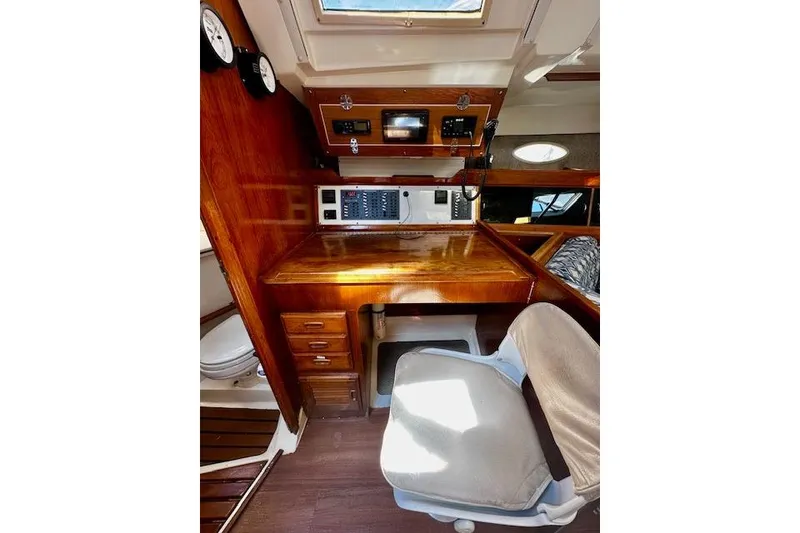 Slide: The Image of 1986 Hunter Passage 450 yacht interior with navigation station and wooden cabinetry. - 25