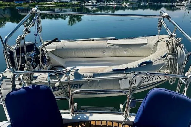 Slide: The Image of Hunter Passage 450 sailboat with inflatable dinghy on calm water, 1986 model. - 3