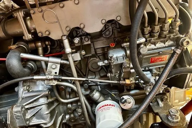 Slide: The Image of Engine of 1986 Hunter Passage 450 sailboat, featuring Yanmar components and intricate mechanical details. - 40